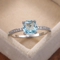 Elegant silver ring featuring a square blue zircon center stone and micro-paved diamonds - US 6 / Aqua