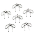 Flat lay of six silver hollow bow alloy pendants for DIY necklace and jewelry making - No. 14 Bowknot-Silver-19*23mm