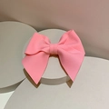 Close-up of pink layered bow hair clip made of premium ribbed fabric on white stand - Hair Clip / Pink