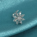 Silver snowflake nose stud with clear zircon stones on a blue textured fabric background - Style C / White Zirconia