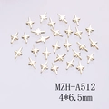Macro shot of 4x6.5mm gold cross star metal charms for DIY nail art and decorations - Gold Four-Pointed Star (A512)