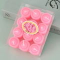 Detailed top view of 12 pieces pink round tea light candles in a transparent plastic box - Pink