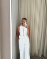 Detail view of a white sleeveless button-down top and matching wide-leg trousers set - S / White