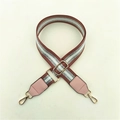 Close-up of adjustable striped fabric strap with pink leather ends and gold-tone hooks - Pink