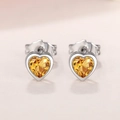 Detailed view of heart-shaped earrings with yellow crystal and silver bezel setting - Yellow