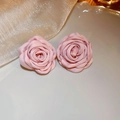 Detailed macro view of elegant pink fabric rose flower stud earrings on a ceramic dish - 25# Silver Earring Post
