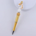 Detail of a golden beaded pen featuring a white and yellow silicone unicorn and rhinestones - Gold Unicorn