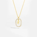 Detailed close-up of 18K gold letter R pendant necklace with sparkling pavé zircons - Letter R