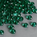 Macro shot of emerald green faceted crystal glass beads with light refraction and center holes - Malachite green