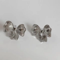 Detailed view of silver bow-shaped stud earrings featuring a brushed metallic texture - Silver Bowknot Style (PD2591)