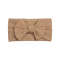 Detail showing the cable knit texture and large bow on a wide nylon baby headband - Coffee