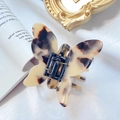 Bow-shaped acetate hair claw clip with tortoise shell pattern on elegant white silk - Butterfly Shape / Tortoise