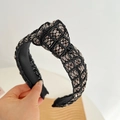 Detail shot of a black braided headband featuring metallic beads and textured fabric - Black Wide Knot Headband