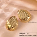 Macro view of gold teardrop earrings with textured waves and stainless steel details - Stainless Steel 3D Wave Studs