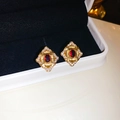 Macro view of vintage gold flower earrings featuring red gemstones and zircon pavé - Golden Vintage Ruby Flower (21#)