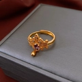Detailed macro view of an adjustable gold ring featuring a purple stone and crystals - Gold Purple Gemstone Open Style (20#)