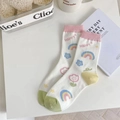 Cute white crew socks featuring rainbow and cloud prints with a pink ribbed cuff - One Size / Pink