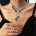 Silver jewelry set with teardrop blue stones and crystals on a female model - Y-Shape Teardrop Set / Blue