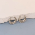 Detailed view of silver hoop earrings featuring intricate diagonal textured engravings - Silver Wheat Ear Texture