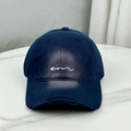 Detail of navy blue cotton baseball cap featuring worn distressed holes and em embroidery - Navy Blue