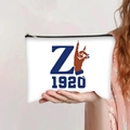 White canvas pouch featuring blue letter Z and 1920 print held by a person - Zeta Phi Beta Greek Style (jiayingpbb0272)