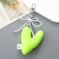 Detail of neon green PU leather heart keychain with pearl bow and metal charm - Fluorescent Green