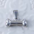 Vintage silver bone-shaped stainless steel pendant with a polished reflective finish - Bone / Steel