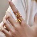 Detail of elegant gold double flower ring with 18K plating worn on a hand - Adjustable Open / Elegant Overlapping 3D Flower (KR0172)