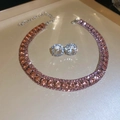 Macro shot of peach pink round crystal necklace and clear zircon stud earrings set - Orange Pink