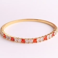 Macro detail of 18K gold plated bangle with red and white square-cut zircon stones - White and Red Zirconia