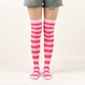 Pink and light pink striped over-knee high socks worn by a model on white background - One Size / Wide Stripe / Pink/Bright Rose