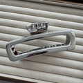 Detailed view of silver metallic shark hair clip on a beige textured jewelry tray - Flat Rectangle Silver 13cm