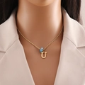 Detail of gold letter U pendant with blue evil eye bead on a twisted chain necklace - Letter U (N1339)