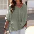 Detail of green linen cotton V-neck shirt featuring short sleeves and button design - Green