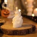 White Gothic skull candle with cobra snake design on a natural wood slice base - Snake-eye Skull / White