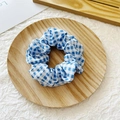 Blue and white checkered pattern fabric scrunchie hair tie on a wooden tray - Light Blue Plaid Check