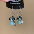 Detailed view of handmade dangle earrings with blue beads and S925 silver leaf pendants - Silver Green