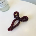 Macro shot of dark red ribbon bow hair claw clip with golden spring mechanism - Cherry Red