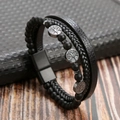 Macro shot of men's multi-layer leather bracelet with tree of life charm and magnetic clasp - Black + Obsidian