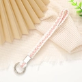 Detail of hand-woven phone strap with white, pink, and gold threads and metal clasp - 12mm Width / Pink & White