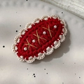 Detail of red knit Christmas hair clip with lace border and pearls on ceramic plate - 26228C Red Base Lace Pearl BB Clip
