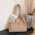 Khaki pleated tote bag with white lace bow and Love patch on a minimalist shelf - Khaki