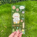 Niedlicher Cartoon-Enten-PVC-Sticker mit floralem Keksmuster in der Hand gehalten - Kleine Ente