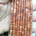 Macro shot of 3x6mm cylindrical jasper stone beads with natural red and yellow marble texture - Red Malachite