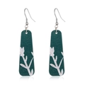 Detail of dark green wooden drop earrings featuring white botanical leaf patterns - Style 48/Long Green Plant Silhouette