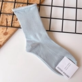 Detail of light blue crew socks with vertical ribbed texture and rolled edge design - One Size / Gray