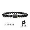 Detail of matte black onyx Aquarius zodiac bracelet with engraved silver charm and gold beads - Aquarius