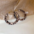 Detail of leopard print fabric wrapped large hoop earrings with golden alloy hooks - Leopard Print Round Hoop Style