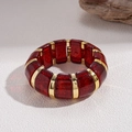 Macro view of wide red glitter resin block bracelet with gold metallic links - Red