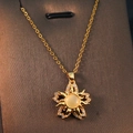 Gold starburst pendant necklace with yellow center stone and cubic zirconia details - Gold - Spinning Sun Flower